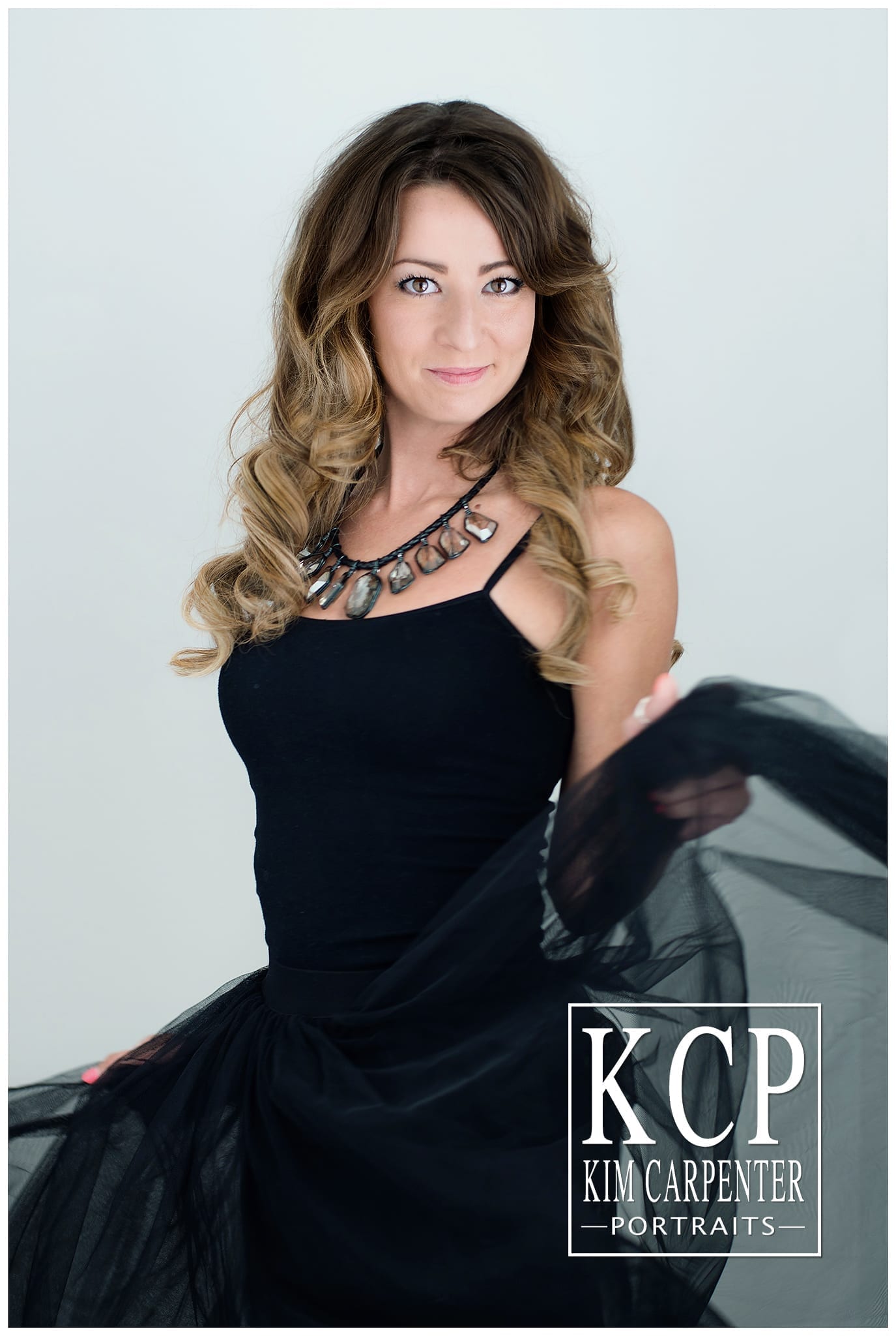 A modern glamour session of a woman wearing a nice black dress. Lakeland Photographer, professional headshots