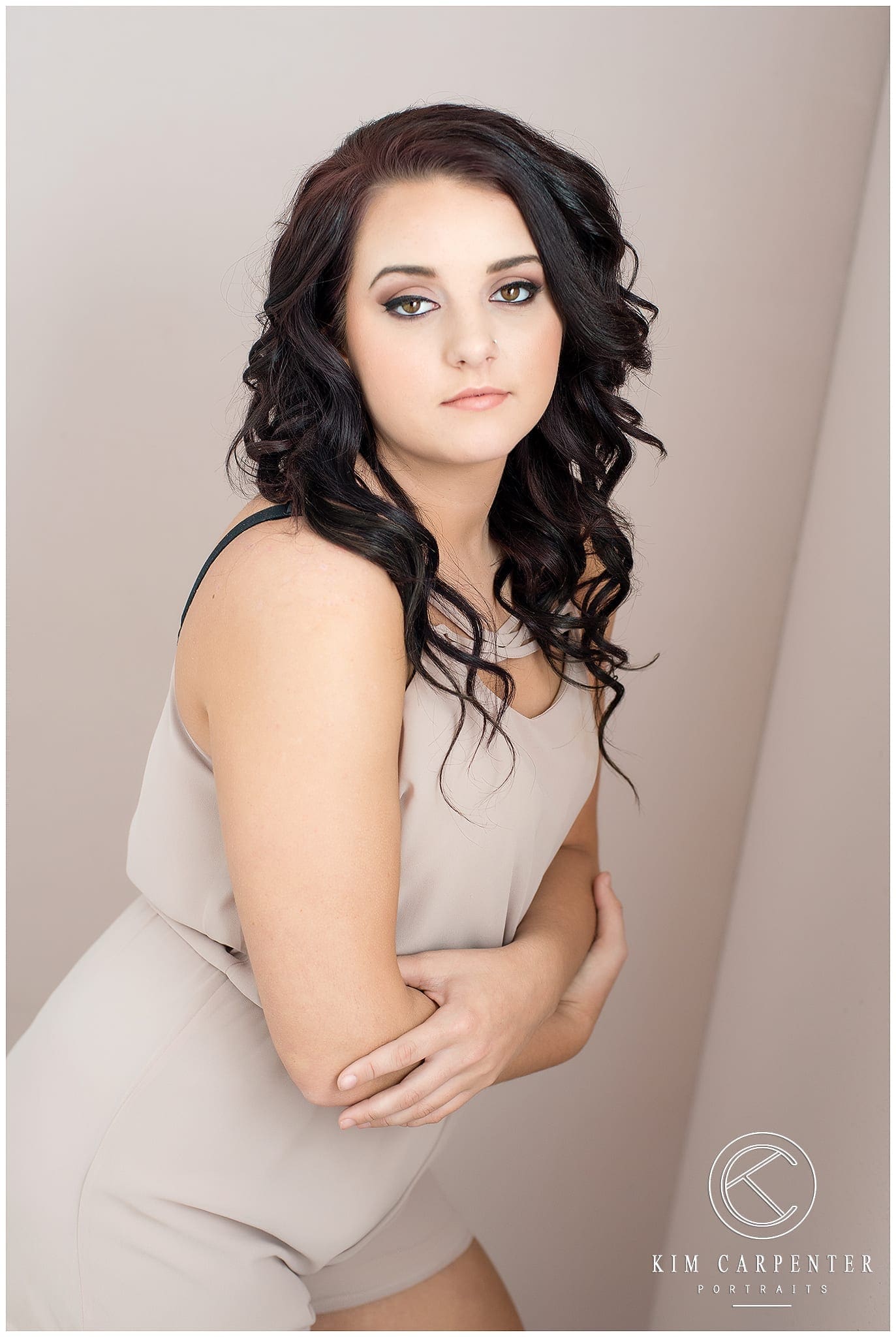 Woman leaning over with a serious face, facing toward camera.